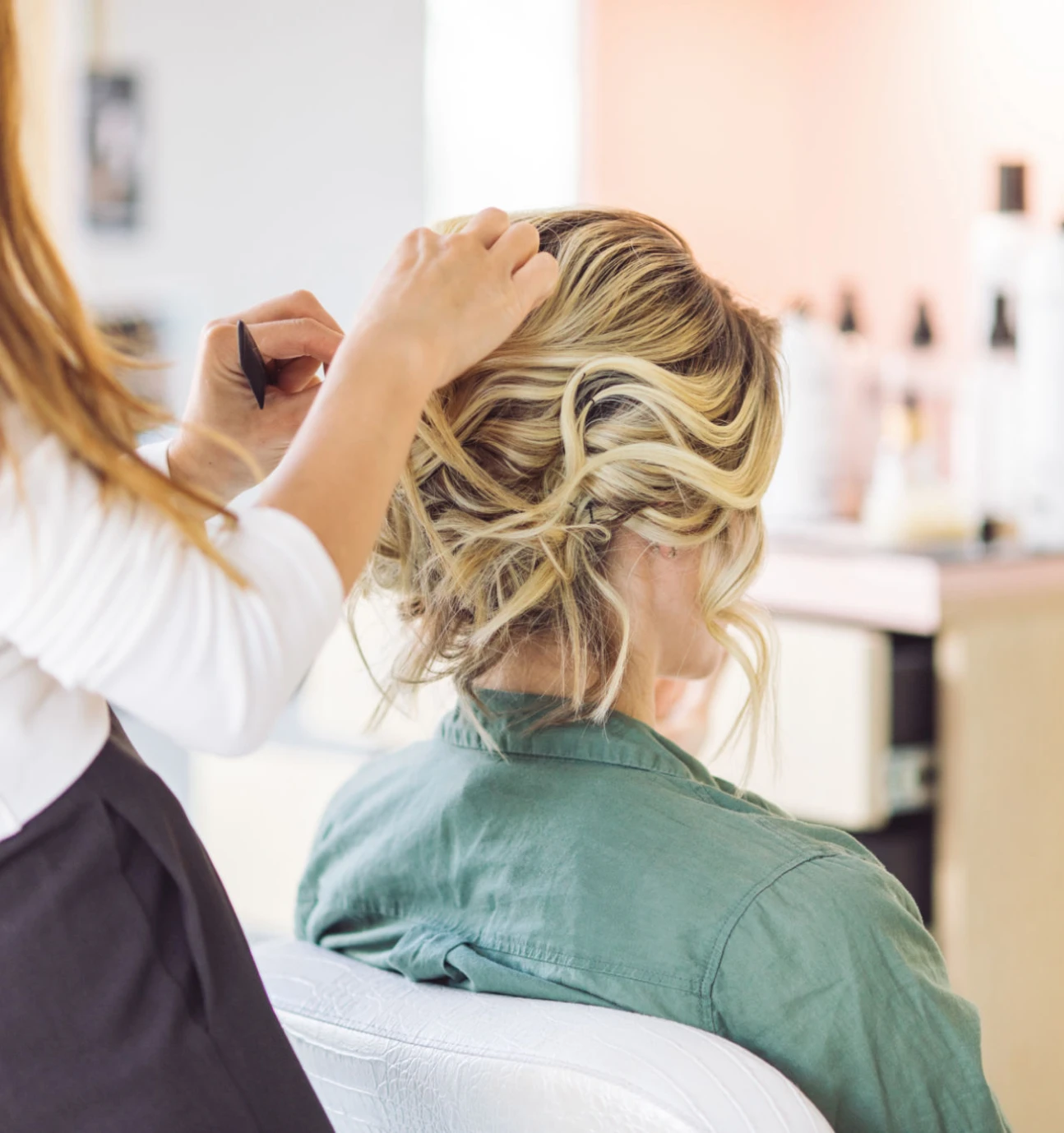 Woman getting hair styled in salon