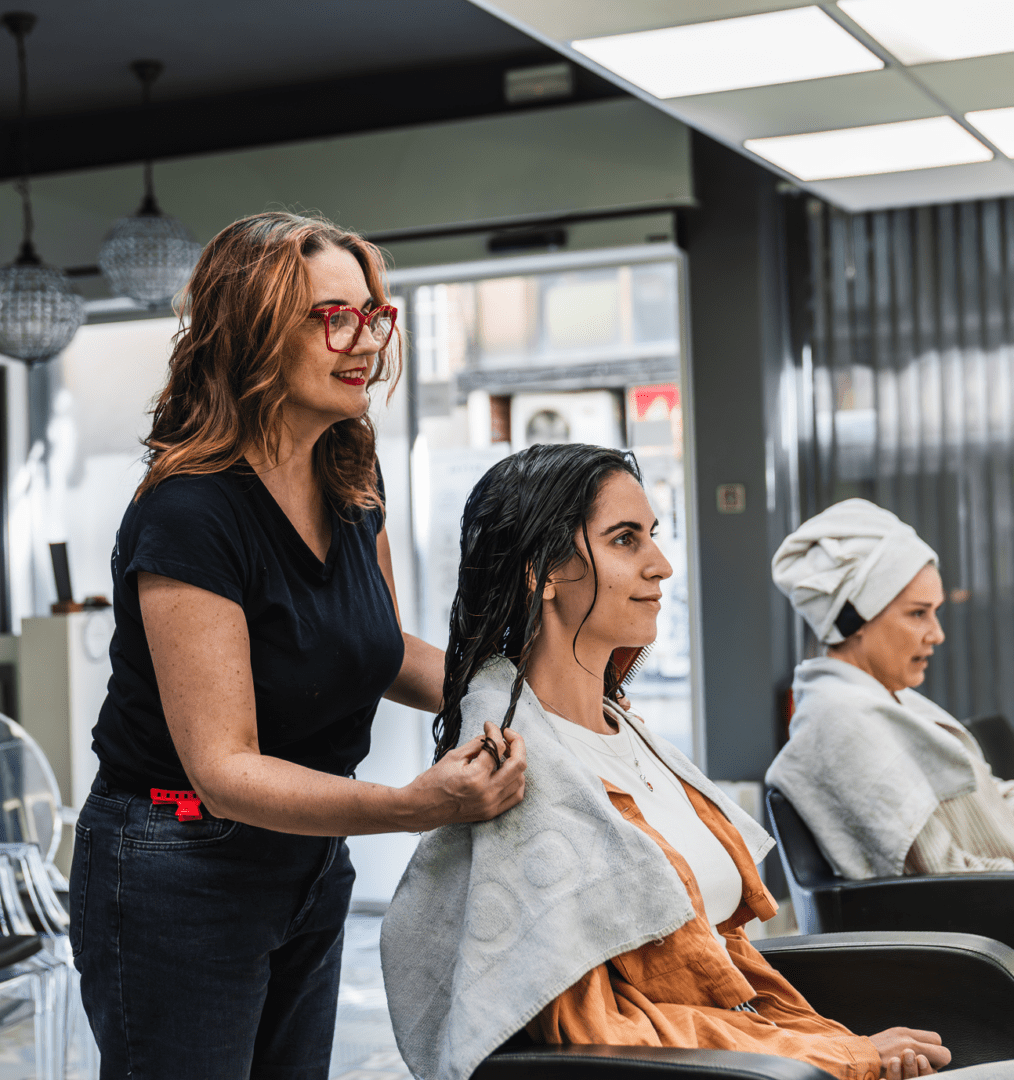 Woman receives hair treatment at salon
