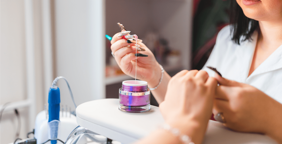 Nail technician applying nail art design