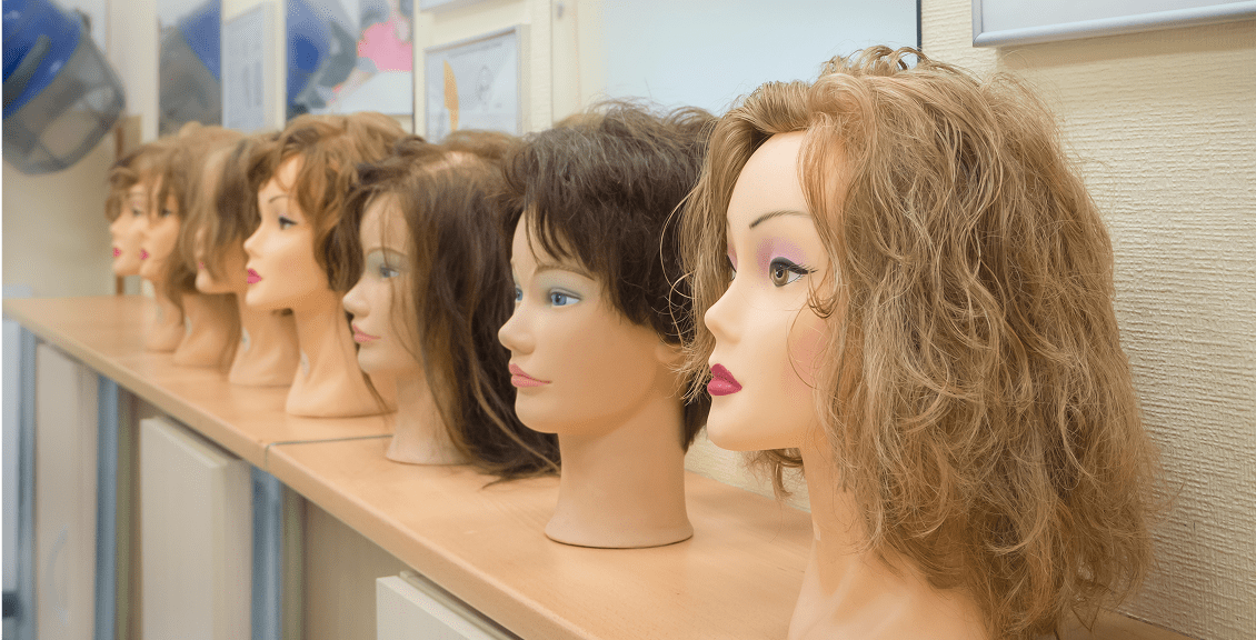 Hair styling mannequin heads in a row