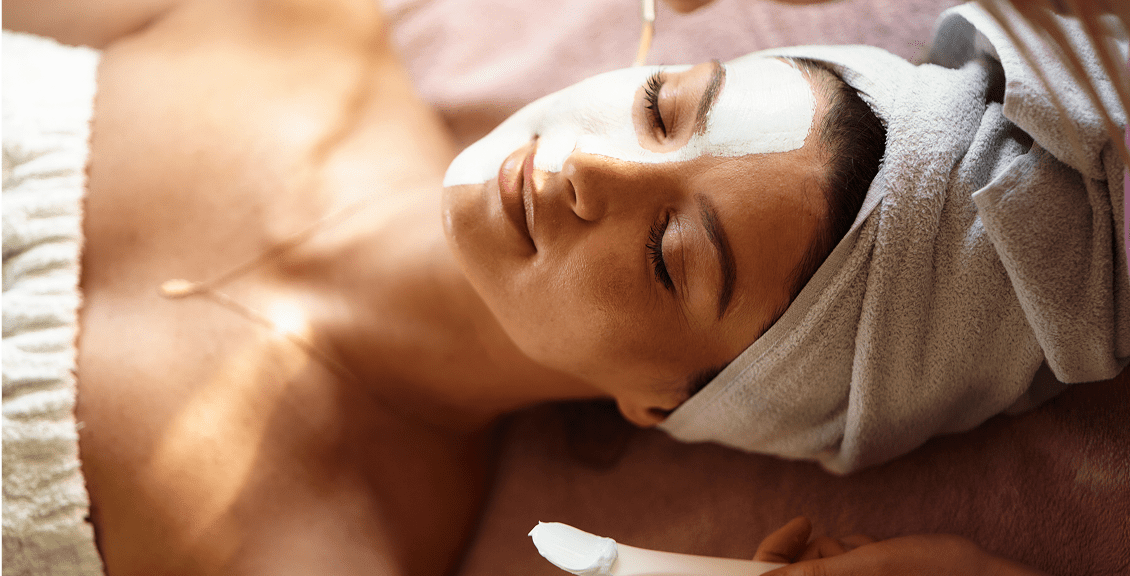 Woman enjoying facial spa treatment