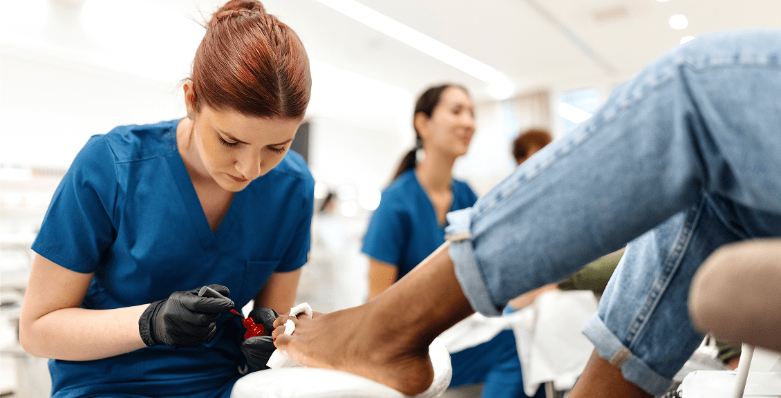 Nail technician applying nail polish