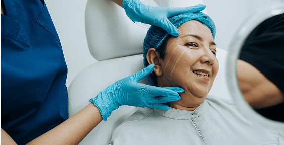 Medical professional adjusting woman's face