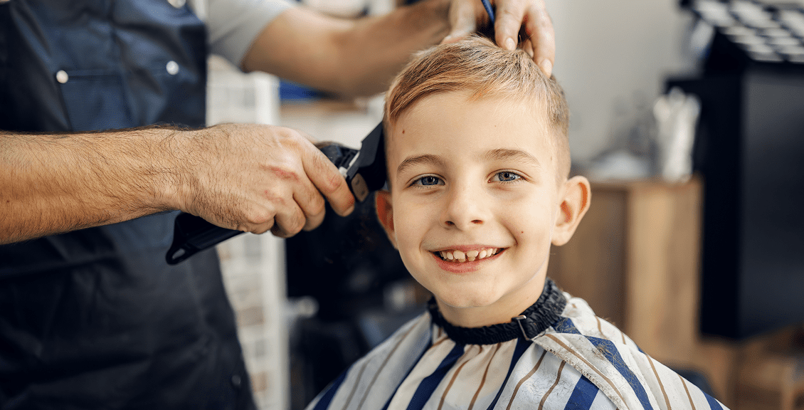 Boy smiling during a haircut