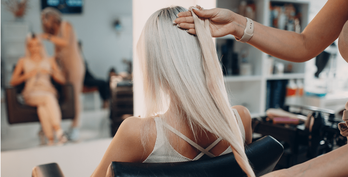 Woman getting hair done in salon