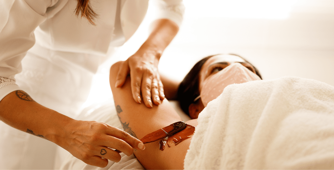 Arm waxing in progress at a spa