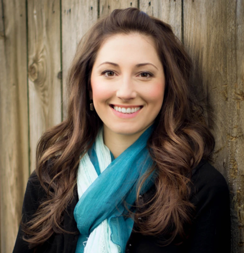 Woman in blue scarf against wooden background